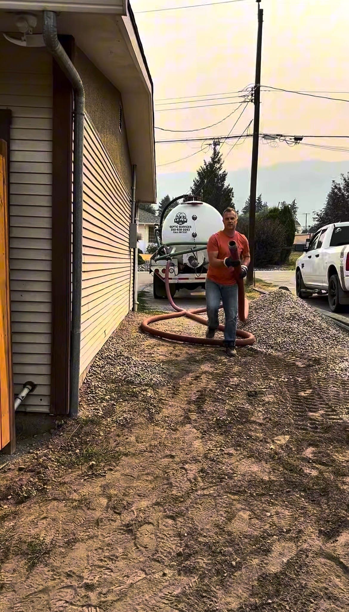 Running a hose to a septic tank beside a house